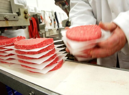  Ground beef patties on a conveyor belt; December 29, 2003, in Yakima, Washington. 