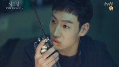 Still image of Lee Je-Hoon from tvN drama “Signal” with his walkie talkie to communicate with detective from the past.