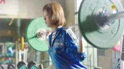 Still image from the official teaser trailer of MBC drama “Weightlifting Fairy Kim Bok-Joo” showing Lee Sung-Kyung serious training in weightlifting.