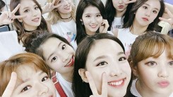 Members of TWICE takes picture in the dressing room before their performance.