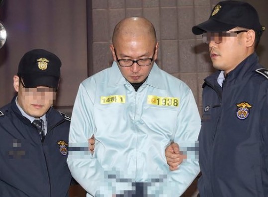 Cha Eun-taek is escorted by police after his arrest in Seoul on charges of abuse of power, coercion and embezzlement.