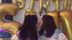 Hara and Sulli kissing on teh lips, celebrating Sulli's birthday.