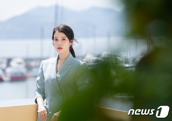 IU shooting with Cannes Beach in the background