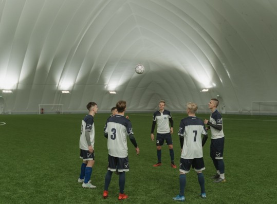 Group of Men Standing on a Soccer Field