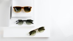 black framed sunglasses on white table