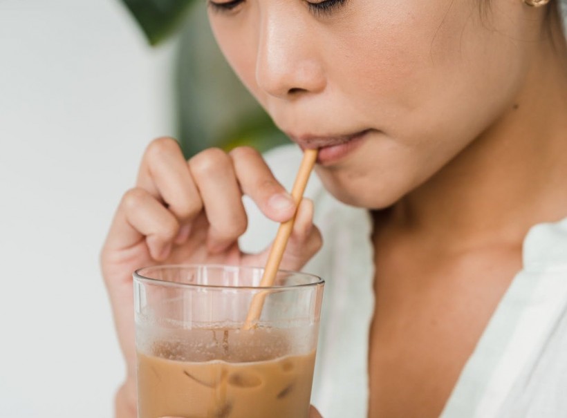 girl sipping coffee with straw