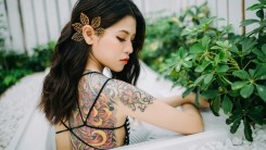 asian woman with back tattoo